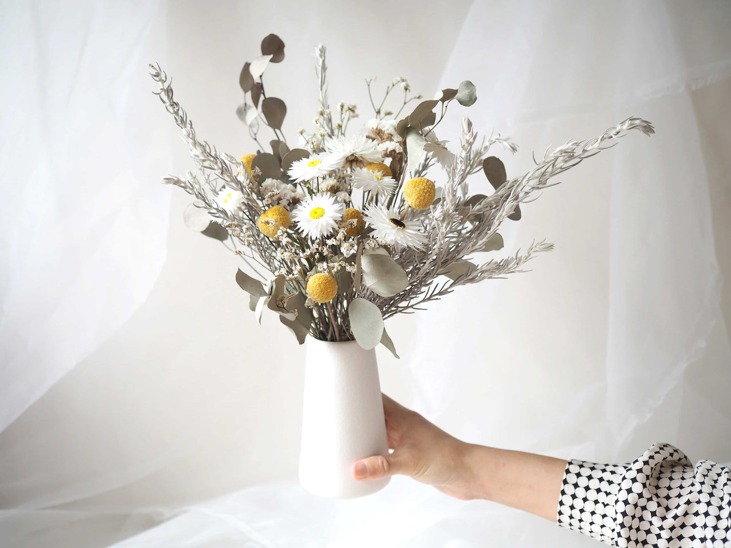 KIRA – native Australian flowers in a tall white ceramic vase