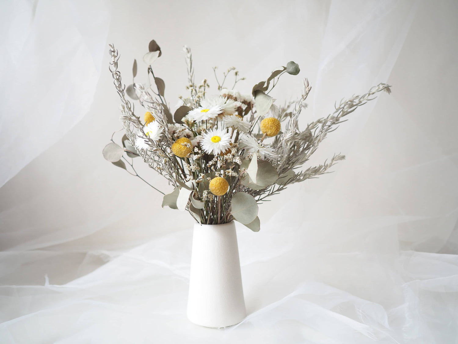 KIRA – native Australian flowers in a tall white ceramic vase